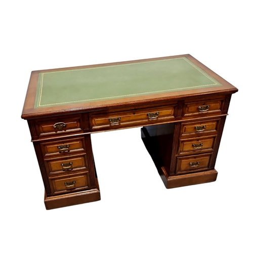 527 - A late 19th Century walnut twin pedestal desk, with green leather top above an arrangement of nine d... 