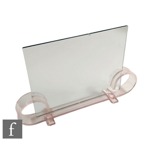 269 - A 1930s Art Deco picture frame, the pale pink acrylic base with scroll ends fitted with two sheets o... 