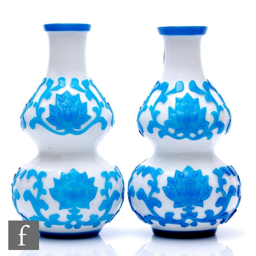 896 - A pair of early 20th Century Peking Cameo glass vases, each of double gourd form, cased in transluce... 