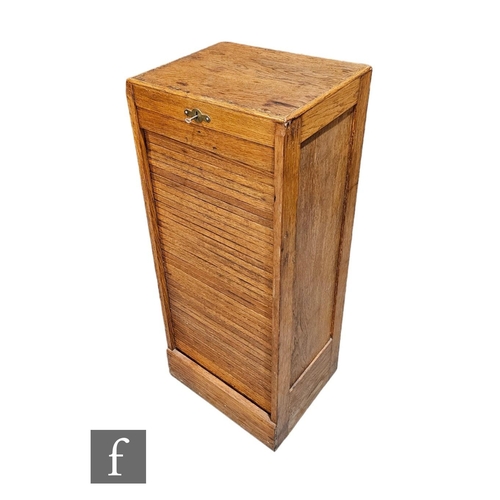 528A - A 1930s oak filing cabinet, the interior enclosed by a tambour shutter door, height 109cm x depth 37... 