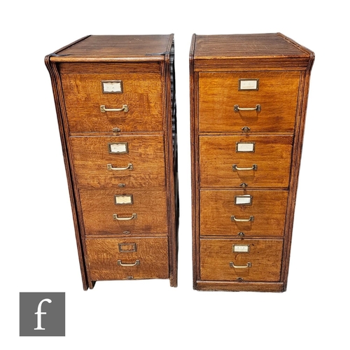 531A - A near pair of 1930s oak four drawer filing cabinets, conforming panel ends, brass handles, height 1... 