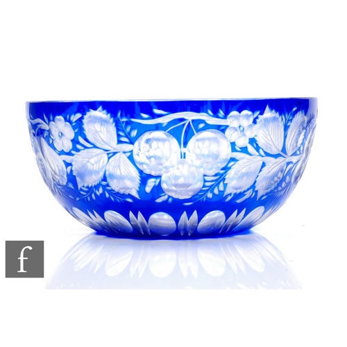 926 - An early 20th Century glass bowl of circular section, cased in blue over clear and flash cut with le... 