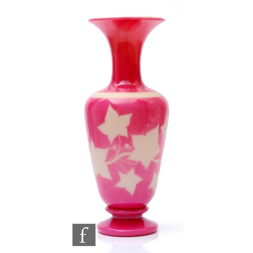 931 - A late 19th Century Richardsons glass vase of baluster form with flared neck, cased in pink over opa... 