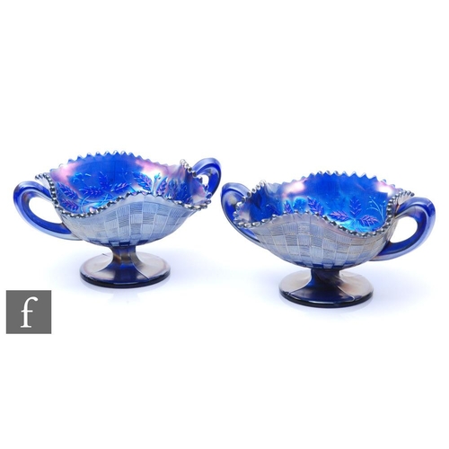 938 - A pair of early 20th Century Carnival glass bon bon dishes with twin handles and wave edged rims, by... 