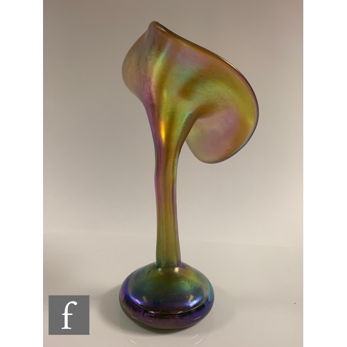 706 - An early 20th Century Louis Comfort Tiffany Favrille glass vase, the compressed ovoid base with a ta... 