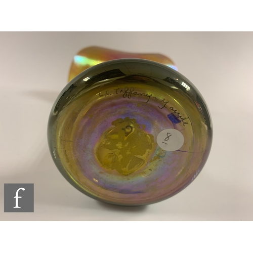 706 - An early 20th Century Louis Comfort Tiffany Favrille glass vase, the compressed ovoid base with a ta... 