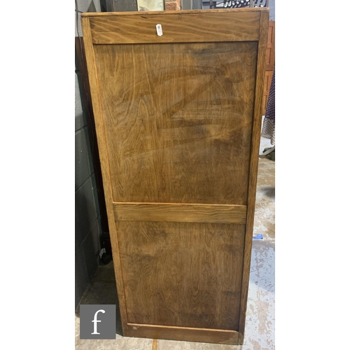 528A - A 1930s oak filing cabinet, the interior enclosed by a tambour shutter door, height 109cm x depth 37... 