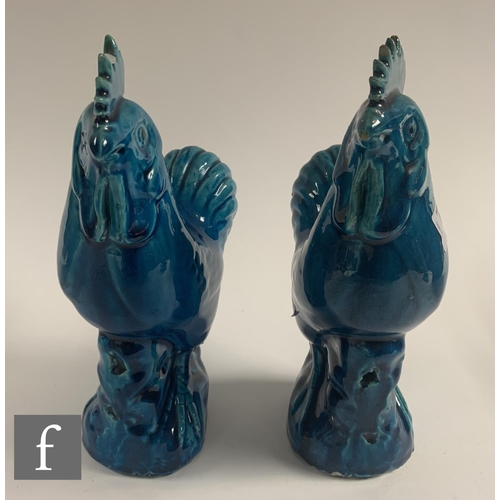 9 - Two late Qing Dynasty Chinese Sancai glazed cockerels, each moulded and raised on rocky outcrop base... 