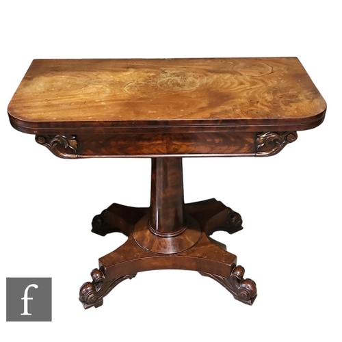 531 - A William IV mahogany fold over tea table with rounded rectangular top above a central pedestal stem... 