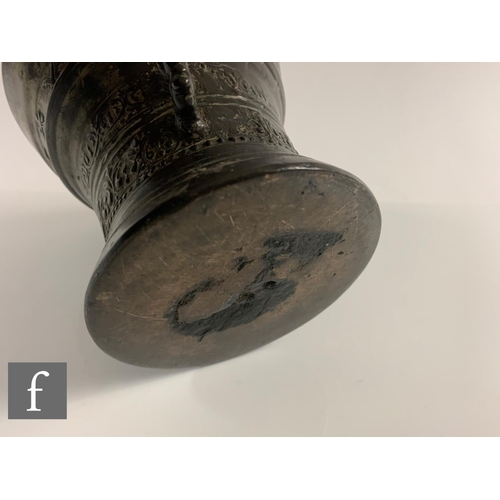 203 - A small continental bronze pestle and mortar with bands of decoration with 'LOF GODT VAN AL 1662', d... 