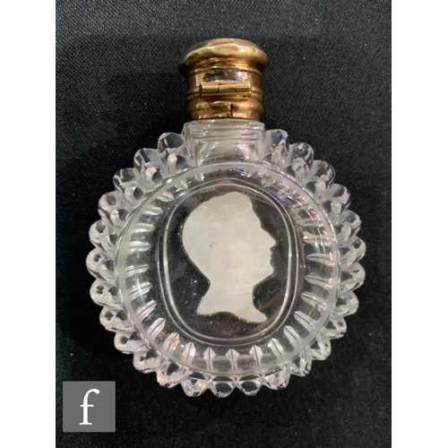 702 - An early 19th Century Baccarat clear crystal scent bottle of ovoid form, with ribbed sides and a cen... 