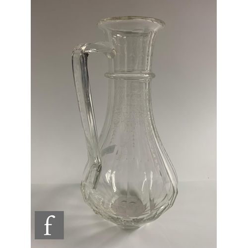 783 - An early 20th Century Lobmeyr clear crystal water jug of low shouldered form with upper collar, inte... 