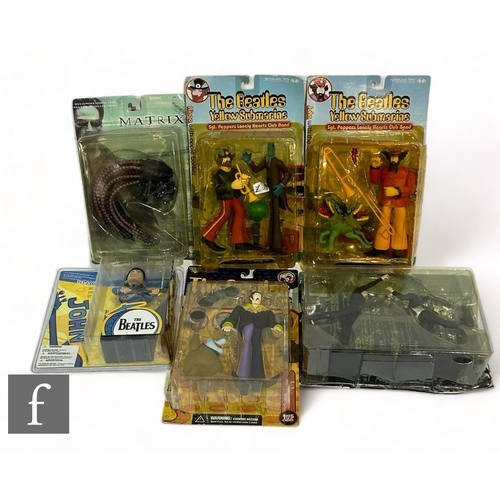 65 - A collection of McFarlane Beatles action figures, comprising three Yellow Submarine, John with Jerem... 