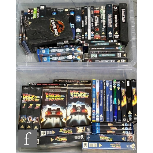 61 - A collection of assorted action and adventure VHS tapes and DVDs, to include Ghostbusters, Independe... 