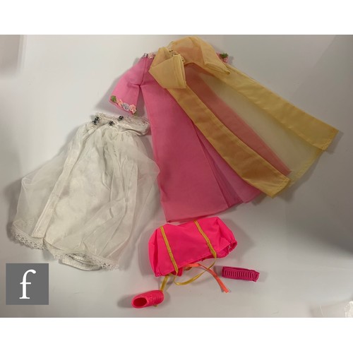 96 - A collection of Barbie clothes and accessories, 1960s-1990s, to include clothes, including 1964 Guin... 