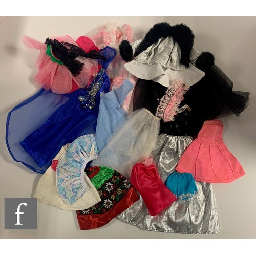 96 - A collection of Barbie clothes and accessories, 1960s-1990s, to include clothes, including 1964 Guin... 