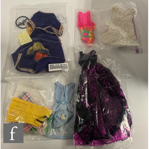 96 - A collection of Barbie clothes and accessories, 1960s-1990s, to include clothes, including 1964 Guin... 