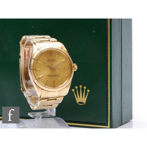 A gentleman's 14ct Rolex Oyster Perpetual wrist watch, gilt batons to a circular champagne dial, case diameter 34mm, to a 14ct Rolex bracelet, total weight 86.5g, ref number 1003/7, with box and papers.