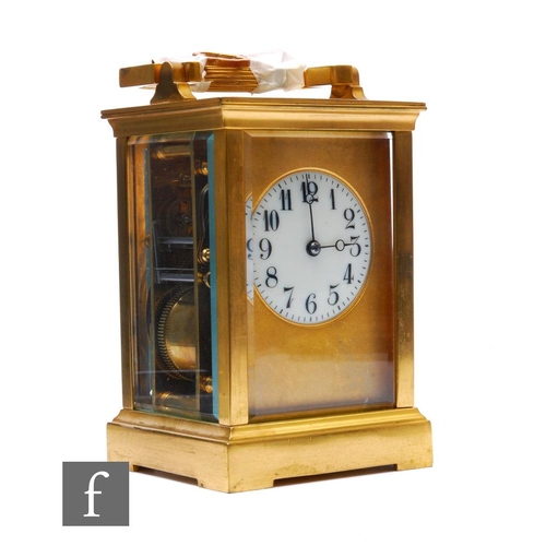 274 - A late 19th and early 20th Century brass carriage clock, circular Arabic dial, bevelled glazed sides... 