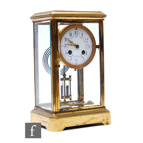 279 - An early 20th Century brass mantel clock with eight day movement striking on a gong, floral swag ena... 