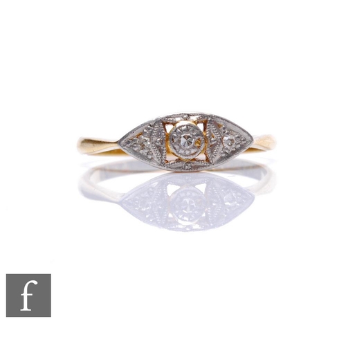 69 - An early 20th Century 18ct diamond three stone ring, stones set to an elliptical shaped pierced head... 