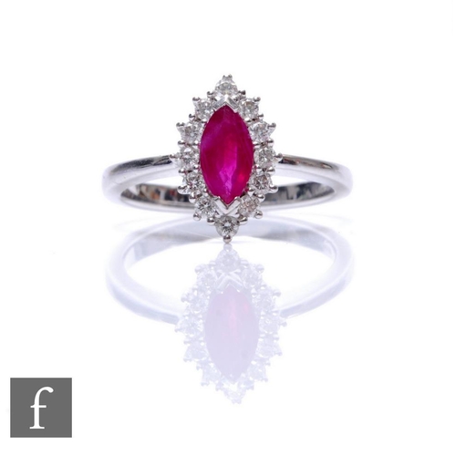 71 - An 18ct hallmarked white gold ruby and diamond cluster ring, central marquise ruby within a twelve d... 