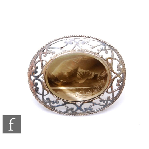 73 - A hallmarked silver and mother of pearl oval brooch depicting a mountainous lakeside scene, weight 2... 