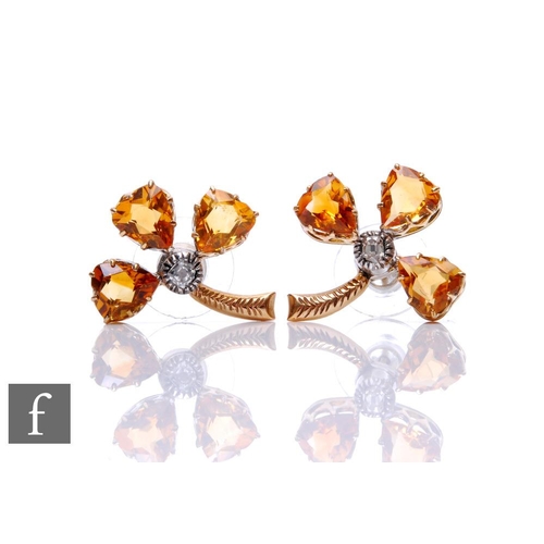 76 - A pair of 9ct citrene and diamond set stylised clover leaf stud earrings, each comprising central di... 