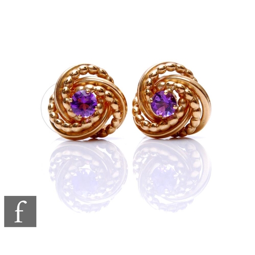 77 - A pair of 9ct hallmarked knot, stud earrings each set with a central single amethyst, total weight 4... 