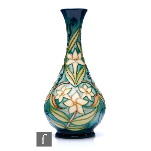 822 - A Moorcroft Pottery vase in the Carousel Jasmine pattern designed by Rachel Bishop, of footed ovoid ... 