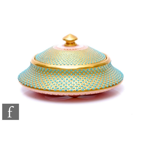 850 - An early 20th Century Coalport porcelain lidded box of squat form, with integrated lid, embellished ... 