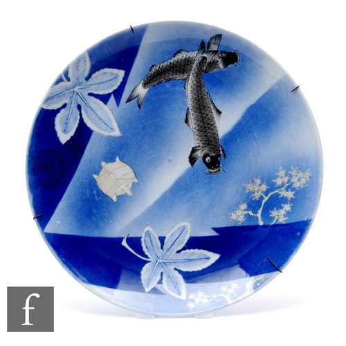 888 - A Japanese fukagawa porcelain charger, the blue ground picked out with swimming carp, diameter 38cm,... 