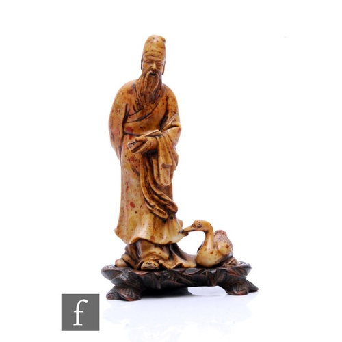 331 - A 19th Century carved soapstone figure of a sage holding a scroll with a swan, on a hardwood base, h... 