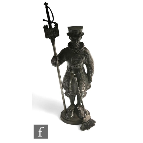 341 - A 20th Century cast iron companion set modelled as a Beefeater holding a castellated standard concea... 