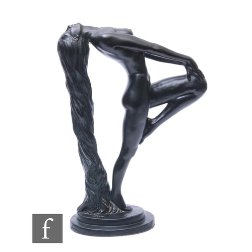 350 - A 20th Century black painted Art Deco style figure of a naked female reclining and holding her knee,... 