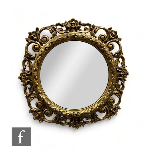 458 - A 20th Century circular gilt wall mirror with raised C scroll and acanthus leaf border, 82cm x 85cm.