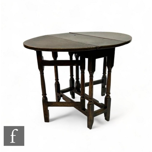 465 - A small 18th Century oak oval drop flap gateleg occasional table, on turned block legs united by rai... 