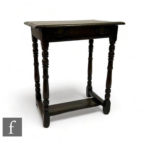 470 - A small 18th Century oak side table fitted with a single frieze drawer, on turned legs united by an ... 