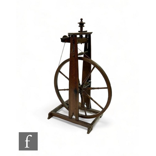 482 - A 19th Century carved oak spinning wheel, 63cm diameter spindle fly wheel, on a platform base, monog... 