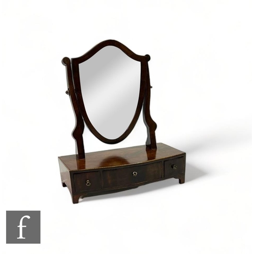 487 - A 19th Century line inlaid mahogany shield back toilet mirror, three fitted drawers on a bracket bas... 