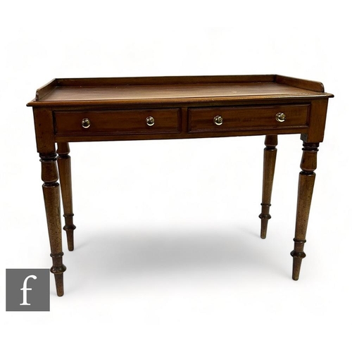 493 - A 19th Century mahogany two drawer wash stand, the tray back over two frieze drawers, later brass ha... 