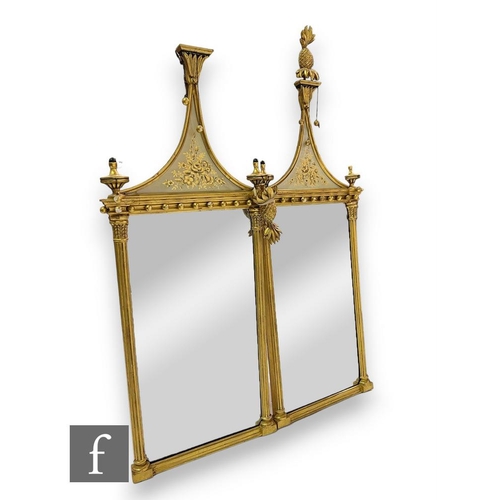 503 - A pair of 20th Century Regency style gilt wall mirrors, the pineapple finials over swept floral glas... 