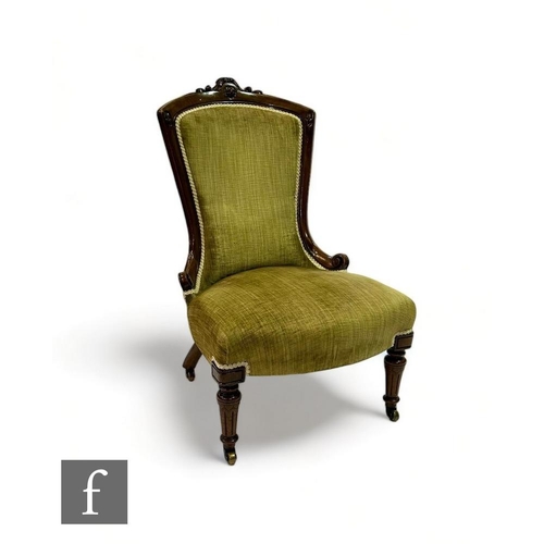 507 - A Victorian carved walnut easy chair with scroll shaped back and turned fluted legs to the front, up... 