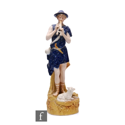 862A - A Royal Dux figure of a shepherd, modelled standing on a rocky outcrop with a lamb at his feet and p... 