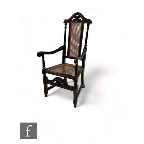 490 - A 19th Century carved oak Carolean style elbow chair, the pierced undulating top rail over a cane se... 