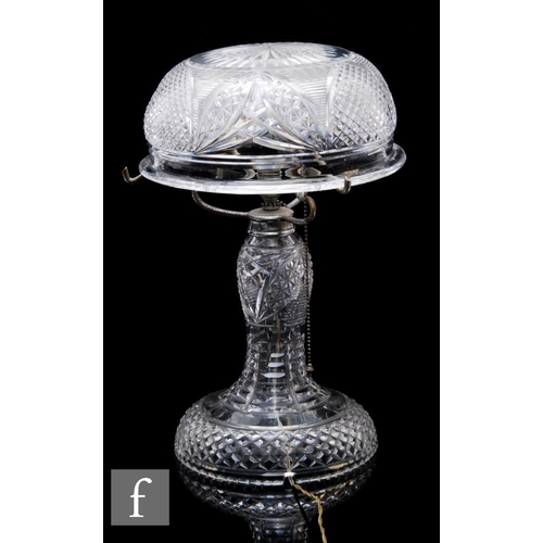 894A - A 1930s cut glass mushroom lamp, the spreading circular base rising to a baluster stem with domed cu... 