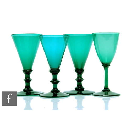 1125 - Three Regency period Bristol green drinking glasses, circa 1839, each with a conical bowl above a pl... 