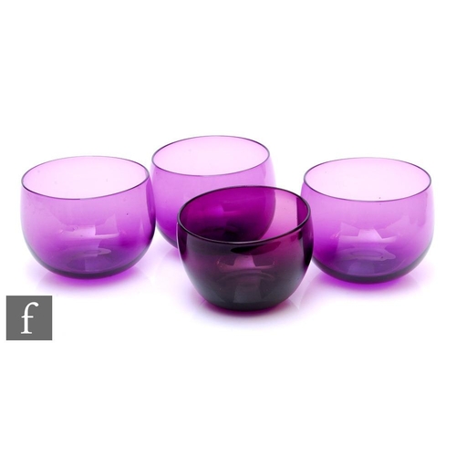 1130 - Three early 19th Century glass finger bowls of plain form in amethyst, diameter 12cm, together with ... 