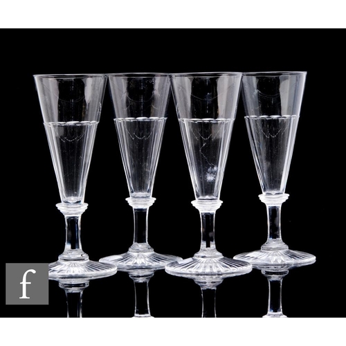 1131 - A set of four 19th Century ale glasses, each with a conical bowl with basal fluting, above a faceted... 