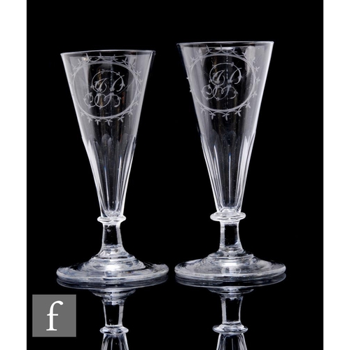 1132 - A pair of 19th Century ale glasses, each conical bowl engraved with a monogram within an oval cartou... 